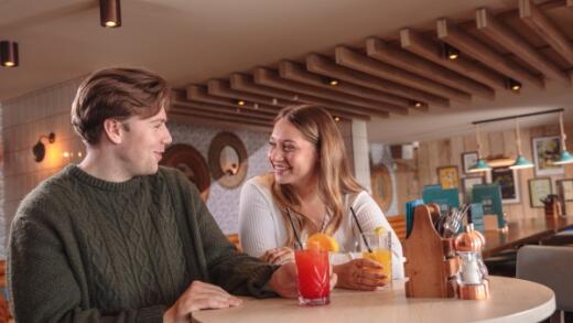 Couple enjoying drinks at The Compass