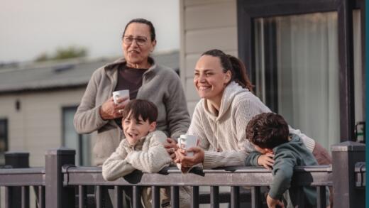 Family on decking of lodge