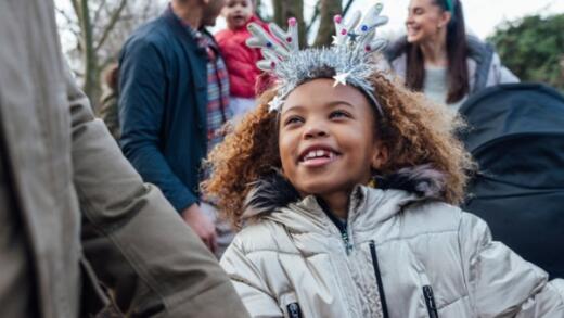 Girl smiling with reindeer ears on