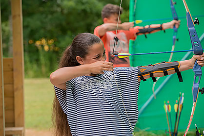 Children lined up for archery lesson