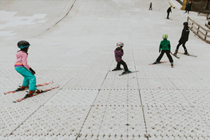 Children skiing on dry slope