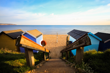 Beach huts on a sunny evening at Milford on Sea