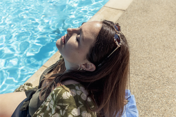 Lady relaxing on poolside