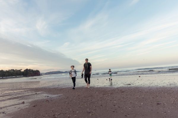 Family walking on goodrington beach