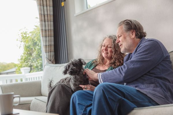 Couple with their dog in a lodge