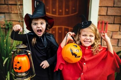 2 girls dressed up in halloween outfits