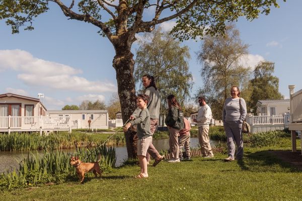 family walking along lakes with caravans