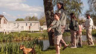 family walking around Hoburne Cotswold lakes