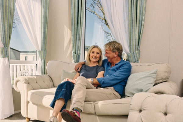 Couple laughing together in their caravan